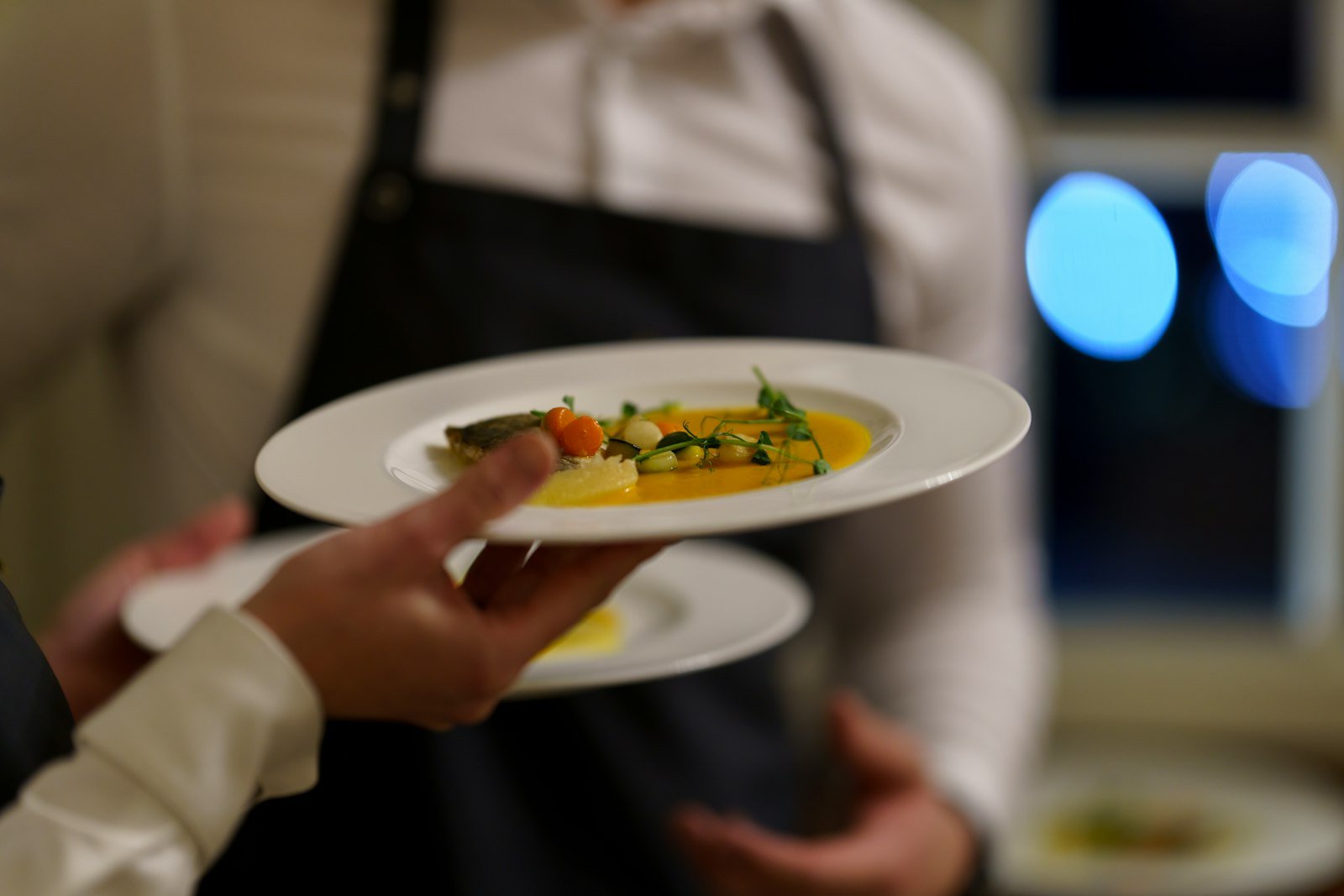 Mesero llevando un platillo en un restaurante